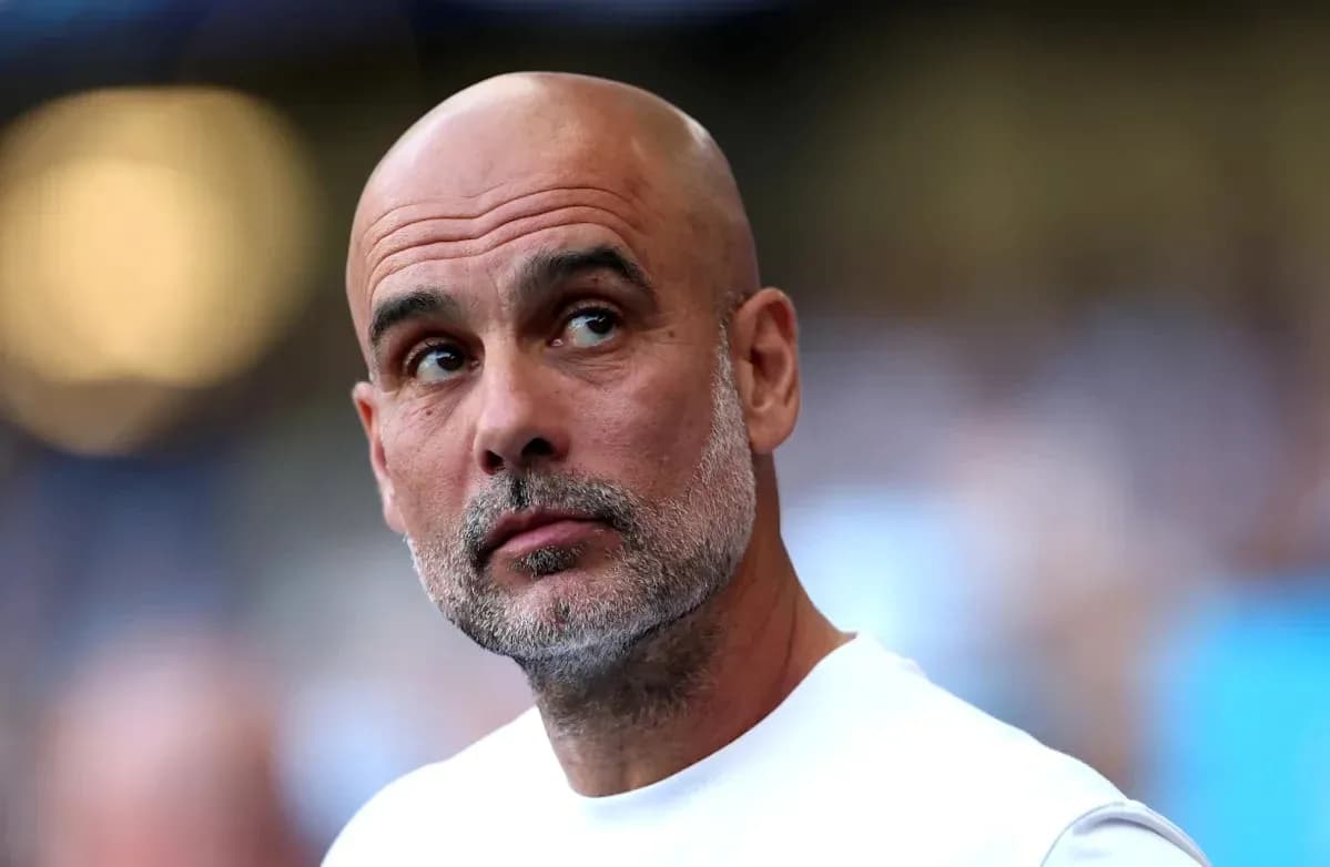Bald coach looking towards the field during match