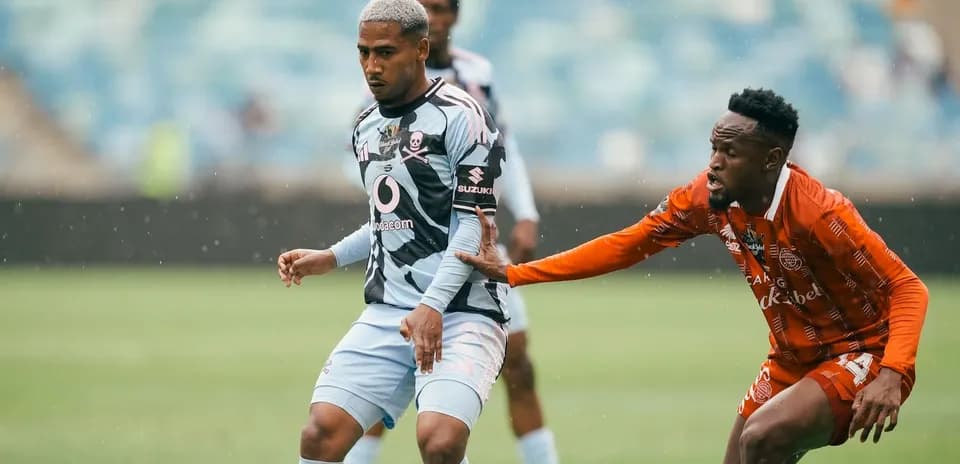 Two players competing for the ball during match