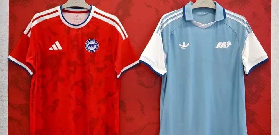 Two football jerseys displayed on hangers