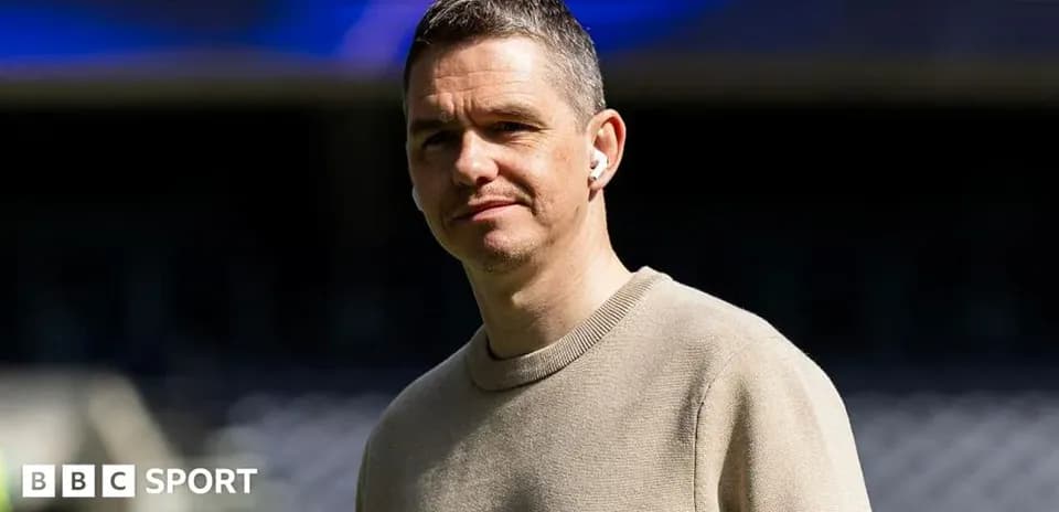 Shirted man with earbuds at stadium