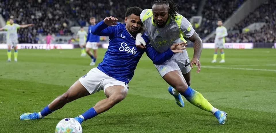 Two players battling for the ball on field