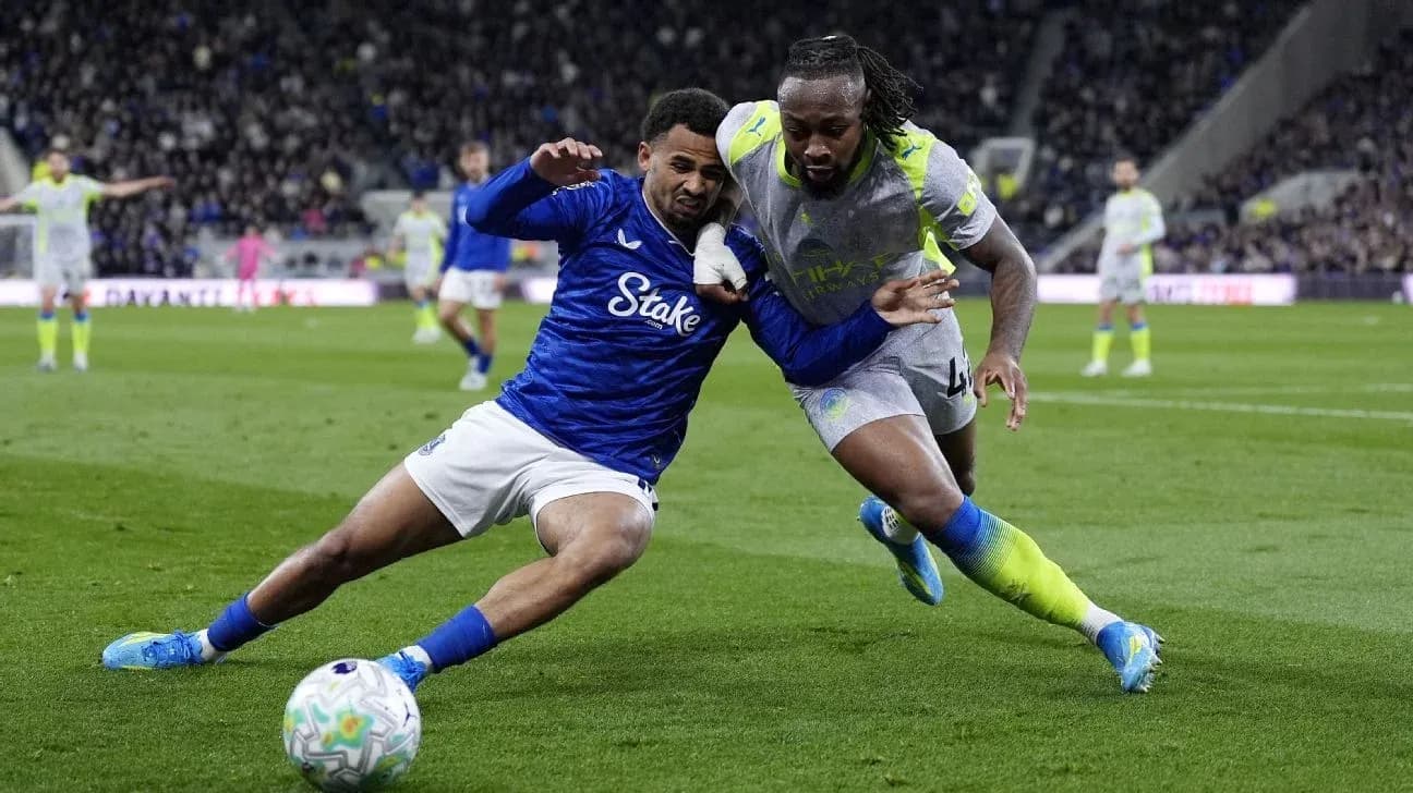 Two players battling for the ball on field