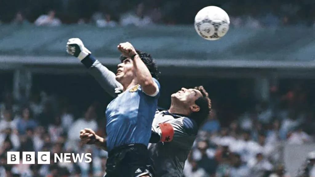 Goalkeeper attempting to catch the ball during match