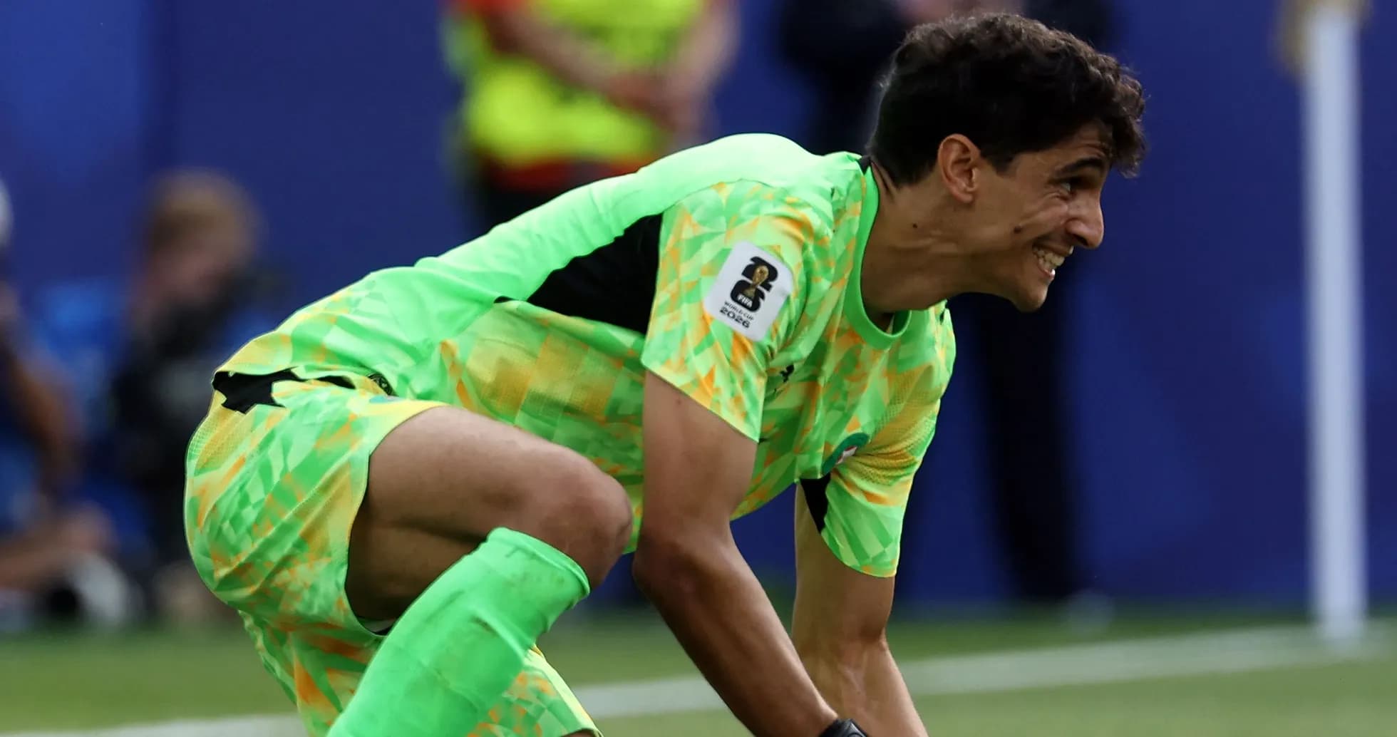 Goalkeeper in bright green kit preparing to play