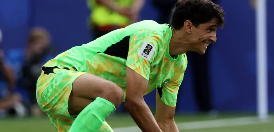 Goalkeeper in bright green kit preparing to play