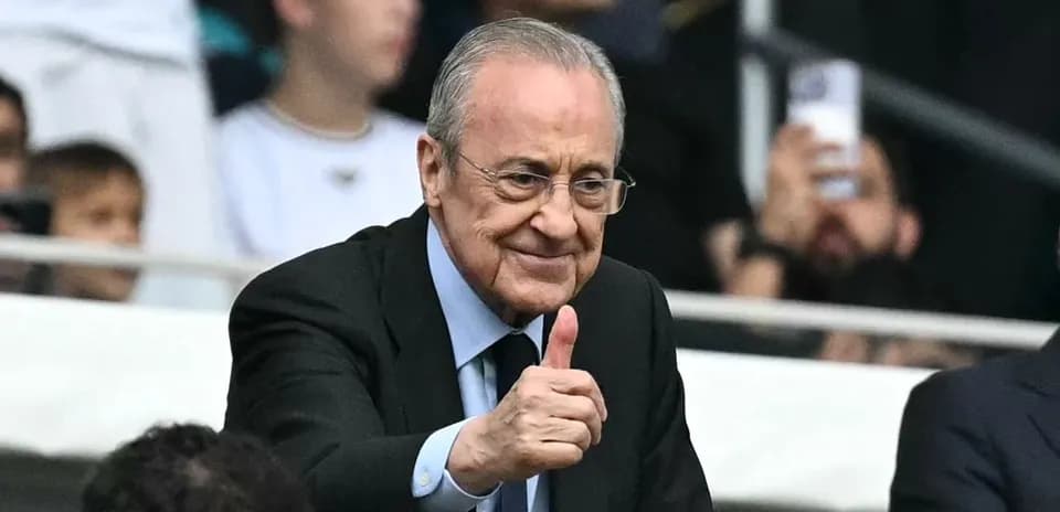 Person giving thumbs up in stadium audience