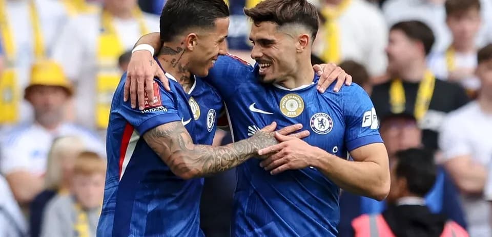Chelsea players celebrating a goal on the field