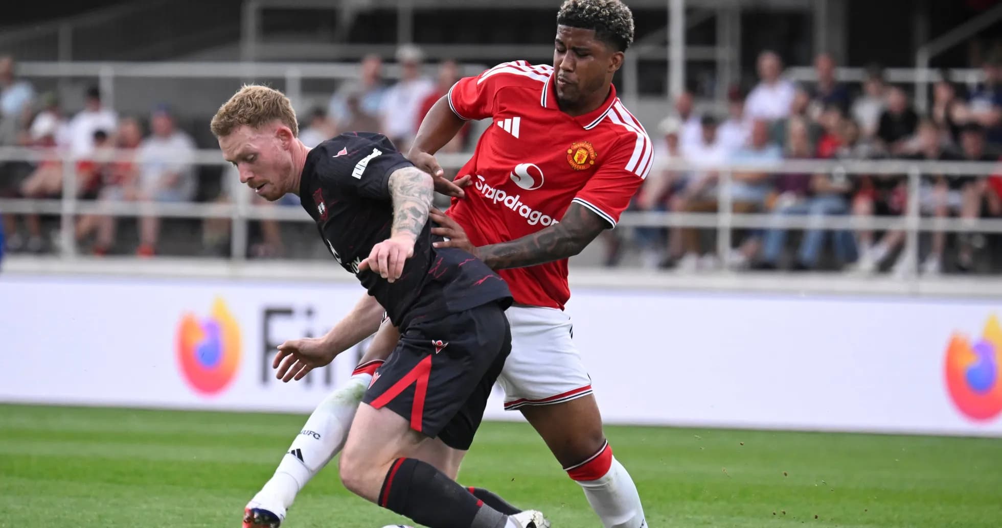 Two players competing for the ball during match