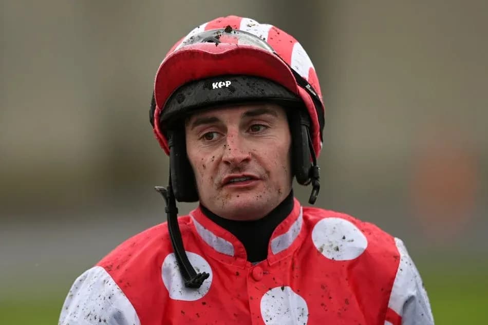 Jockey wearing red and white silks with helmet
