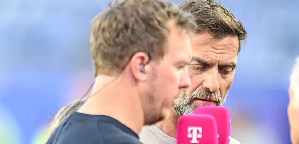Duo interviewing on the field with microphones