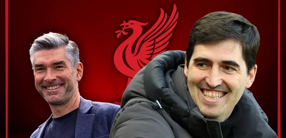 Two coaches smiling against Liverpool background