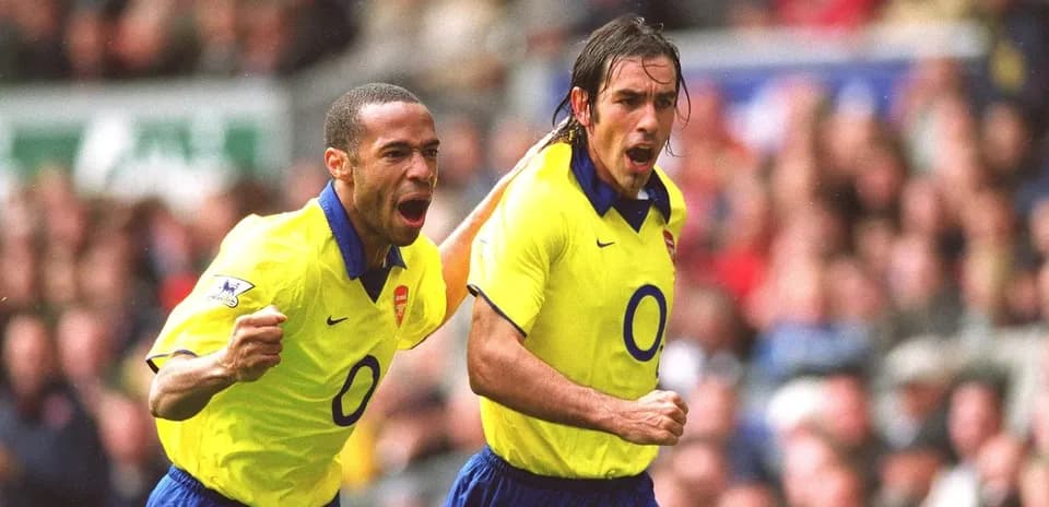 Arsenal players celebrating a goal on the pitch