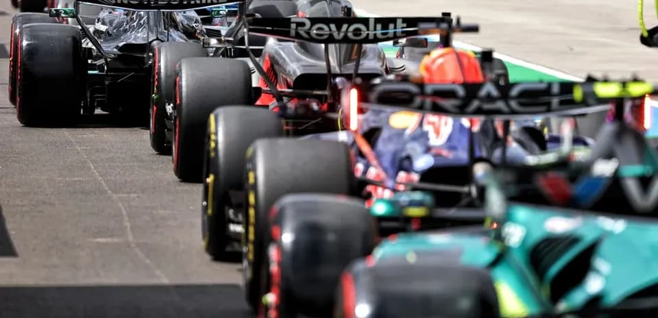 Formula 1 cars lined up in pit lane