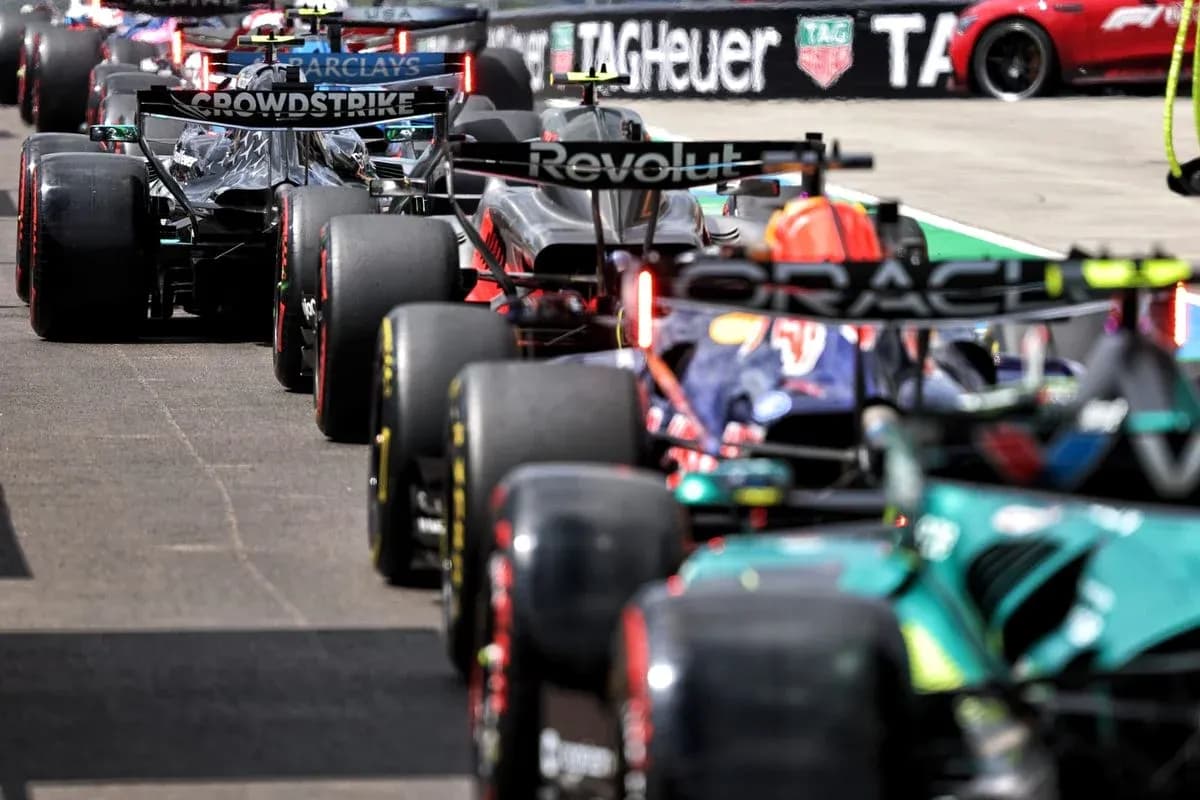 Formula 1 cars lined up in pit lane