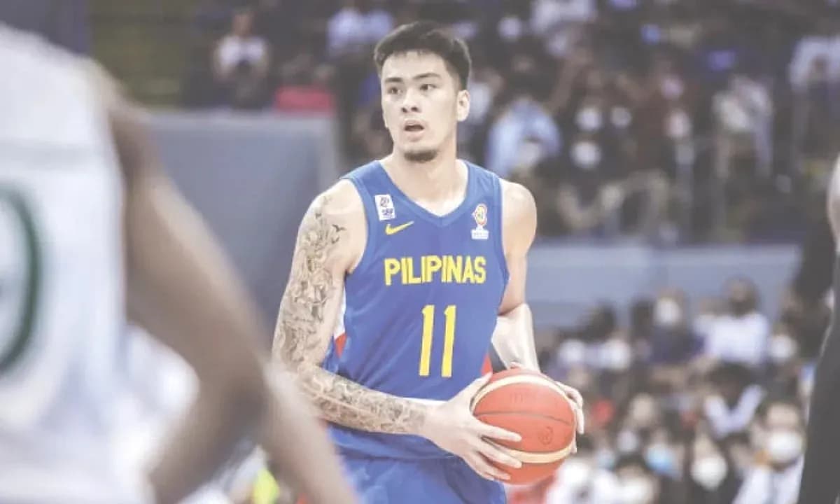 Basketball player in blue jersey holding ball