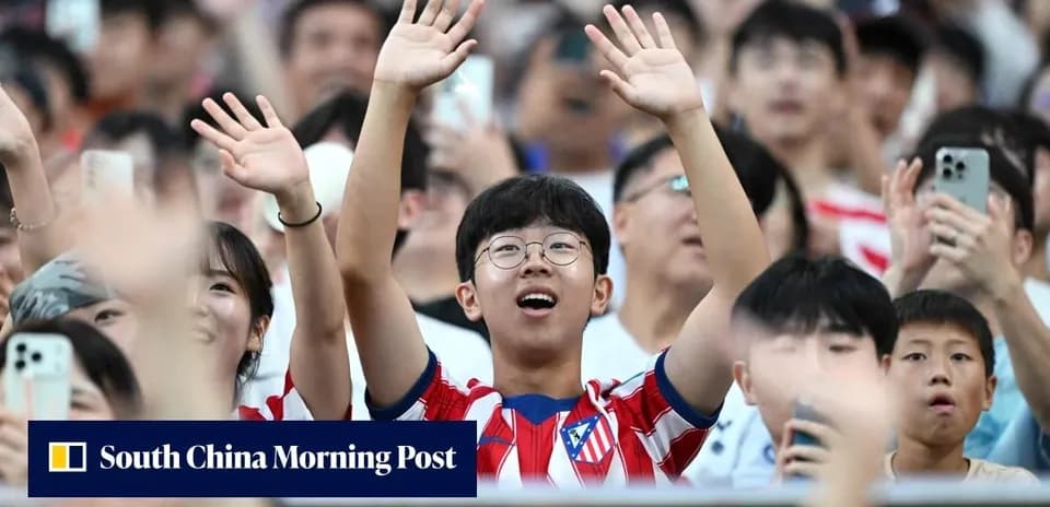 Fans cheering in Atletico Madrid jerseys at stadium