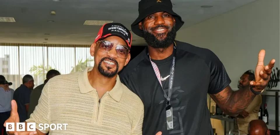 LeBron James and Will Smith posing together indoors