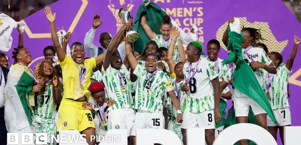 Nigerian women's team celebrating cup victory on stage