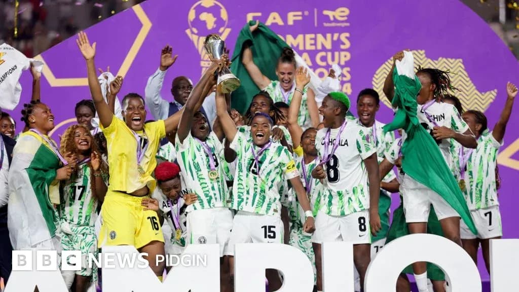 Nigerian women's team celebrating cup victory on stage