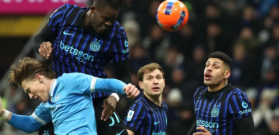Inter Milan player heading ball over opponent