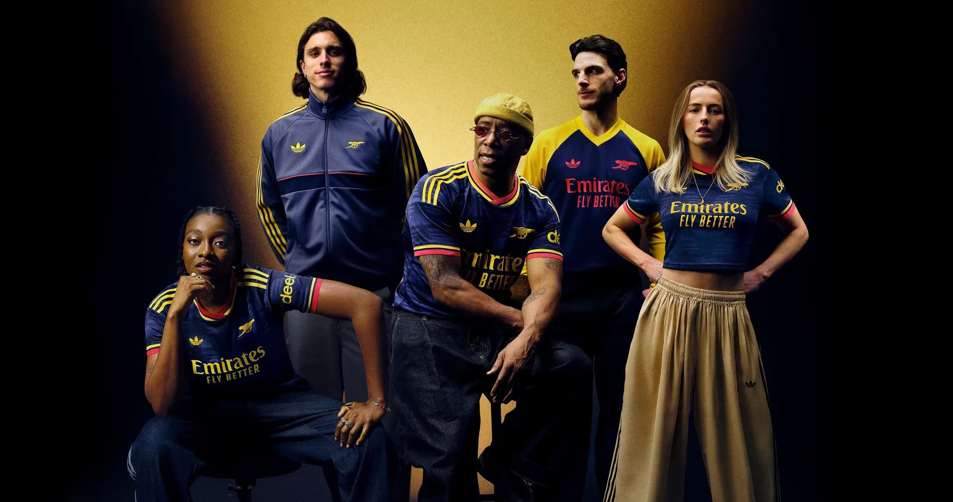 Five individuals posing in Arsenal jerseys and apparel