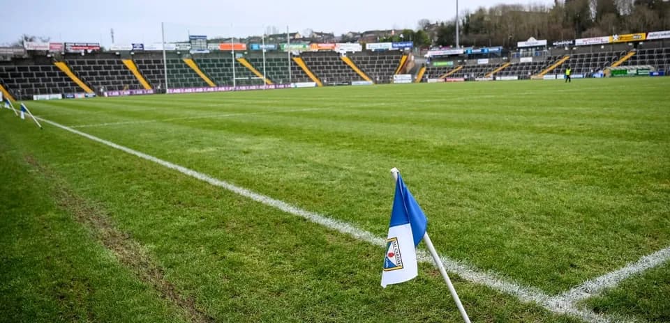 Corner flag on a football pitch with stadium seating