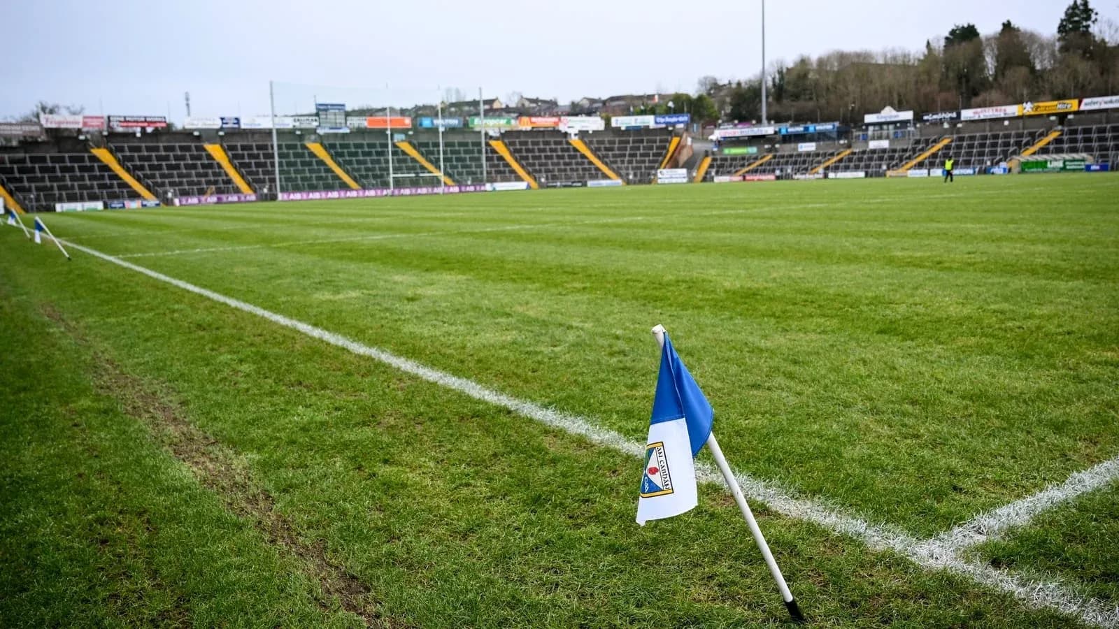 Corner flag on a football pitch with stadium seating