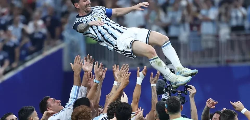 Lionel Messi celebrated by teammates after victory