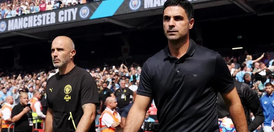 Two football managers walking onto the pitch