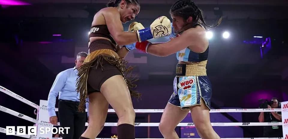 Two female boxers exchanging punches in the ring