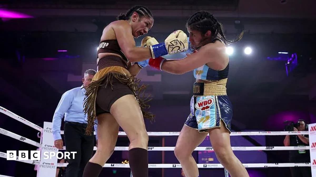 Two female boxers exchanging punches in the ring