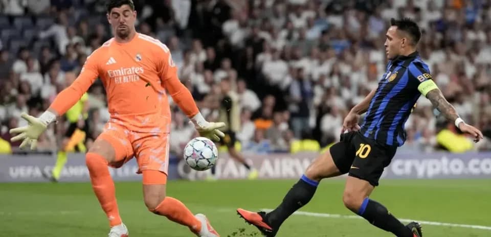 Goalkeeper attempting to save shot from striker