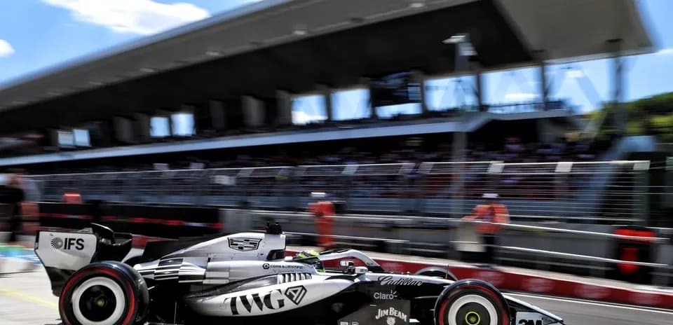 Formula 1 car speeding past pit lane