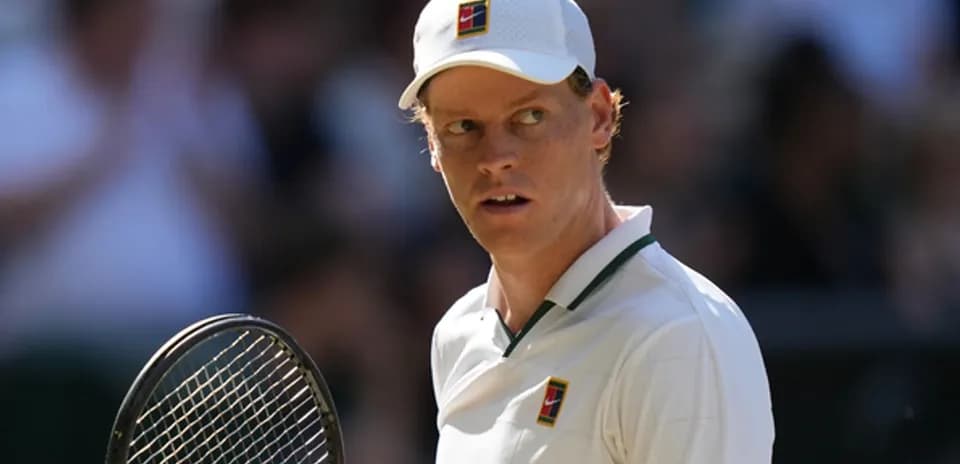 Tennis player preparing to serve on court