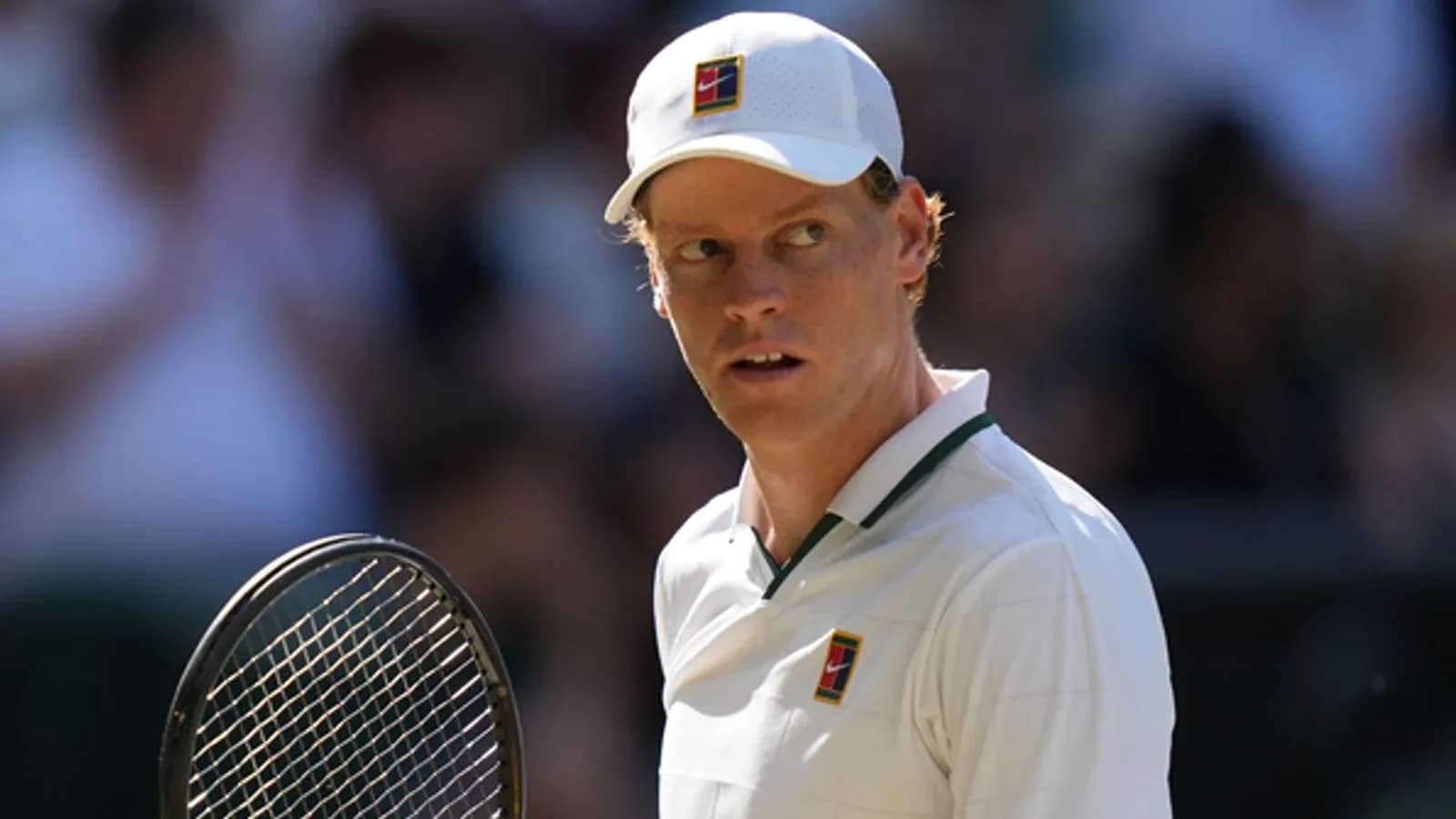 Tennis player preparing to serve on court