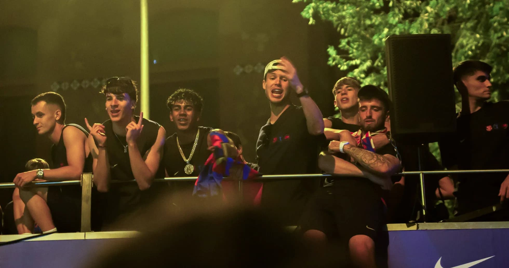 Fans celebrating on a balcony with team colors