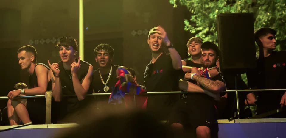 Fans celebrating on a balcony with team colors