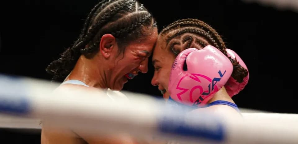 Duo of boxers embracing in the ring