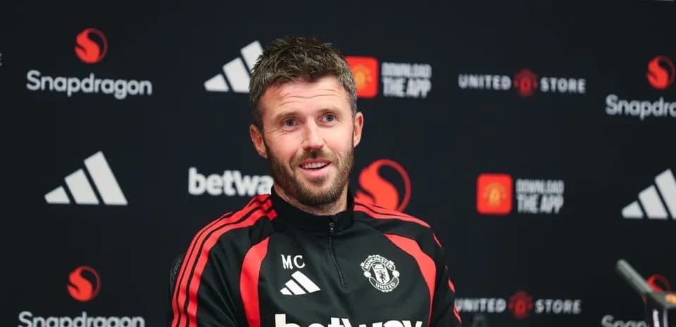 Manchester United coach at press conference podium