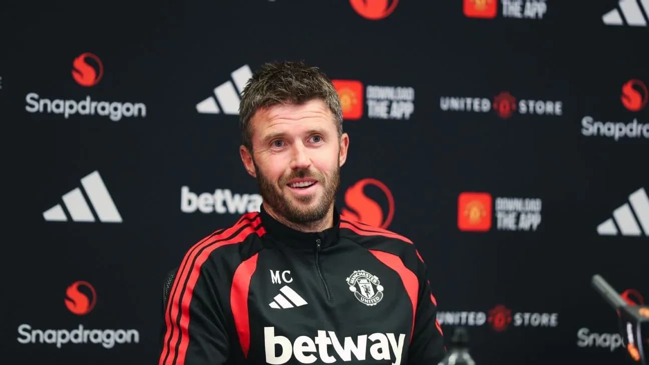 Manchester United coach at press conference podium