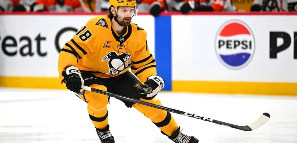 Hockey player skating with puck during game