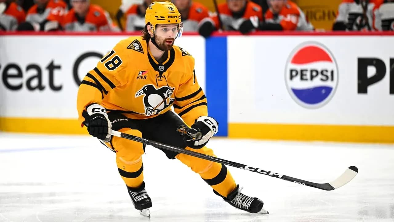 Hockey player skating with puck during game