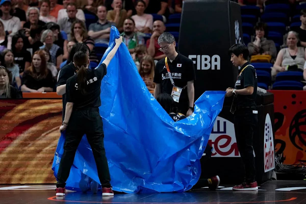 Staff covering court with blue tarp during event