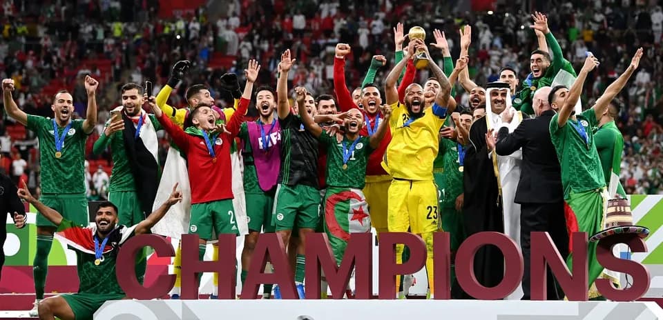 Algeria team celebrating victory with trophy