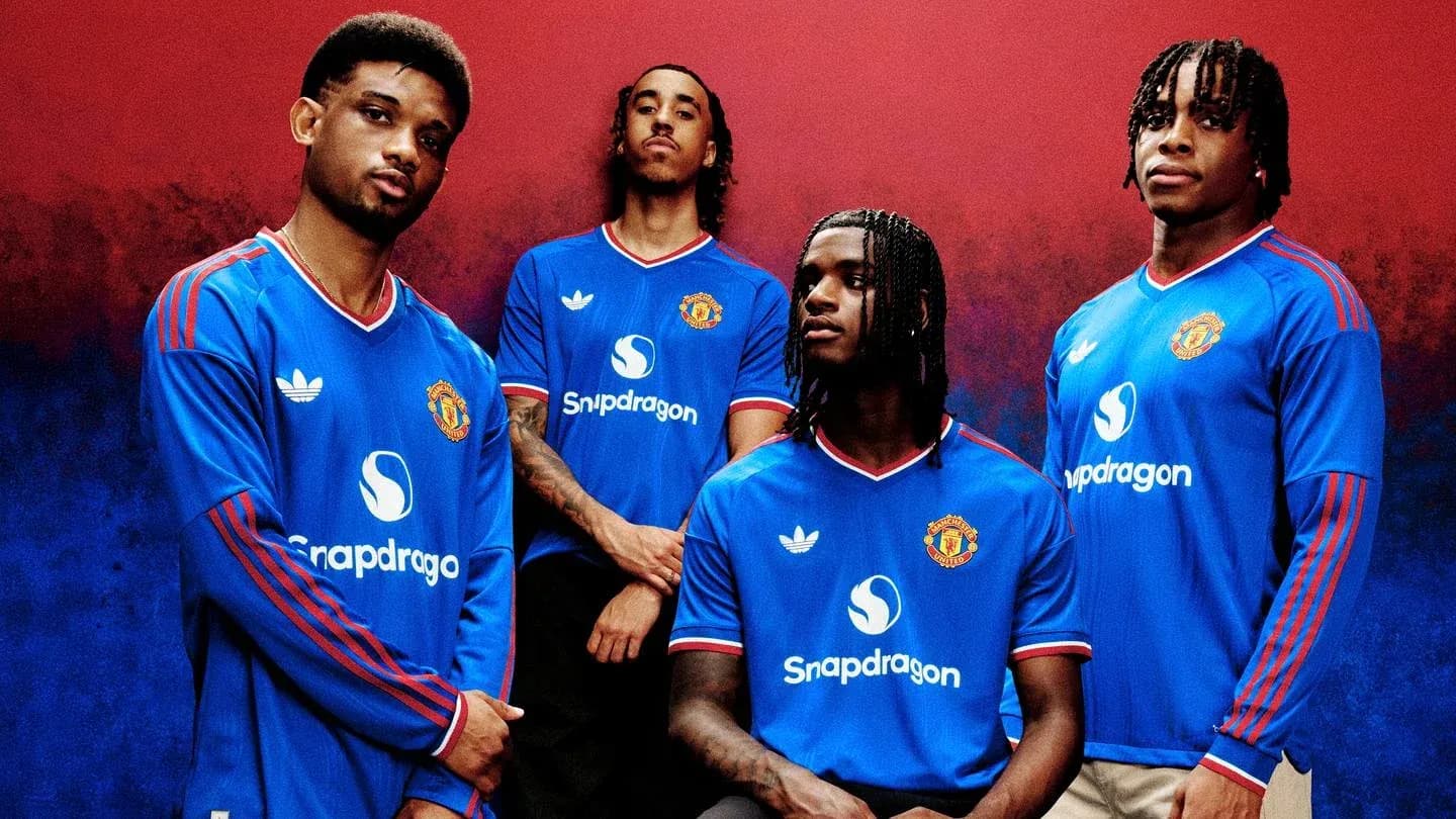 Four players posing in Manchester United jerseys
