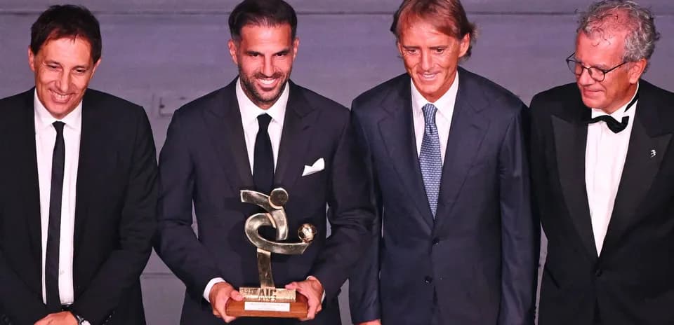 Four men posing with an award at event