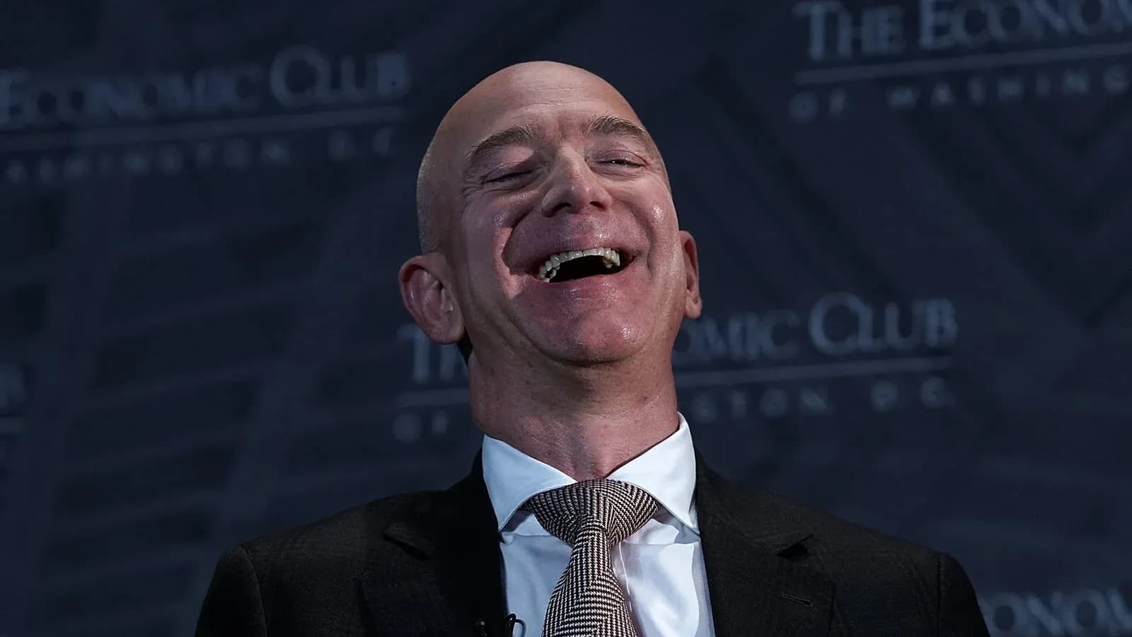 Speaker laughing at Economic Club event
