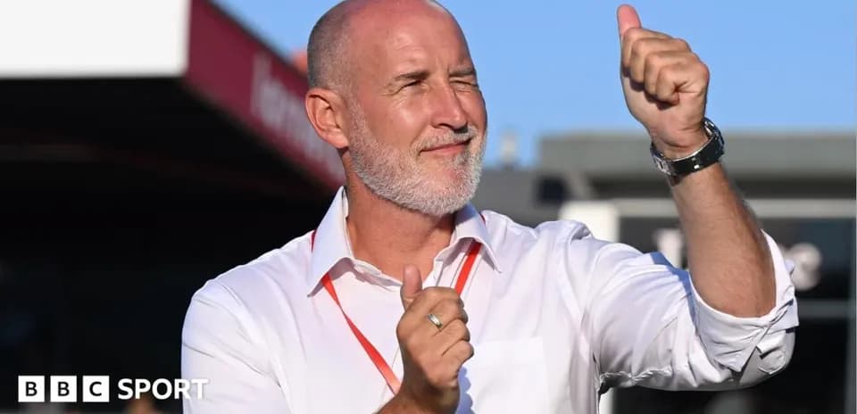 Men coach celebrating with a thumbs up gesture