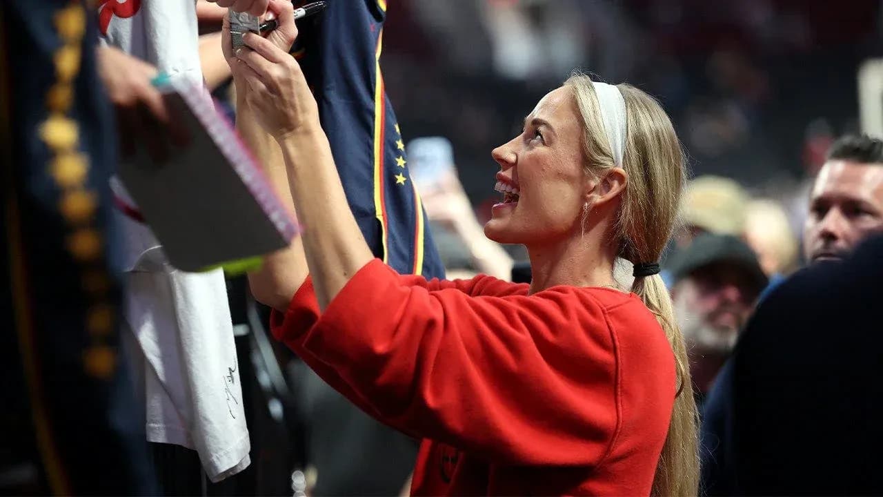 Fan signing autographs at sports event