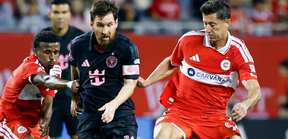 Messi dribbling past defenders in a soccer match